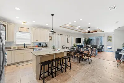 a kitchen and living room with a table and chairs at Family Tides II in Panama City Beach