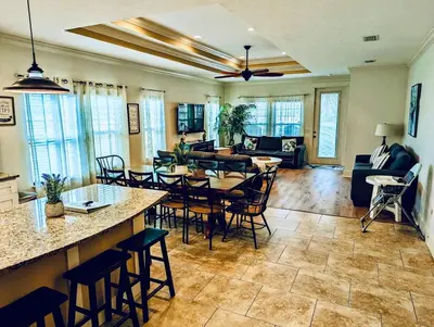 a living room with a table and chairs at Family Tides II in Panama City Beach