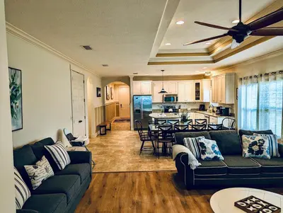 a living room with a couch and a kitchen at Family Tides II in Panama City Beach