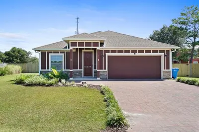 a house with a brick driveway in front of it at Family Tides II in Panama City Beach