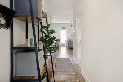 a hallway with a stairwell with a plant at Florida Knights by the Sea in Panama City Beach