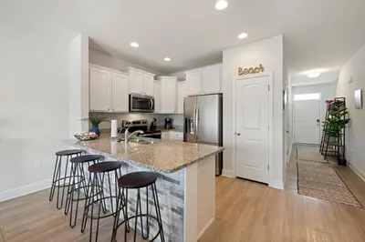 a kitchen with a island with bar stools at Florida Knights by the Sea in Panama City Beach