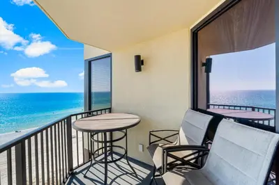 a balcony with a table and chairs and the ocean at Sunbird Resort! Stunning Beach and Ocean Views! by Dolce Vita Getaways PCB in Panama City Beach