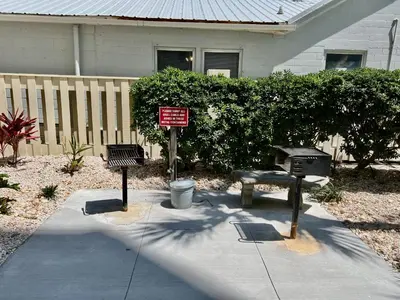 a park with a bench and a sign in front of a house at Sunbird Resort! Stunning Beach and Ocean Views! by Dolce Vita Getaways PCB in Panama City Beach