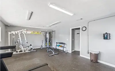 an empty room with a gym with tread machines at Charming Townhouse in Gulf Highland Beach Resort! Amenities Galore in Panama City Beach