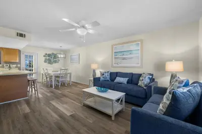 a living room with a couch and a table at Charming Townhouse in Gulf Highland Beach Resort! Amenities Galore in Panama City Beach