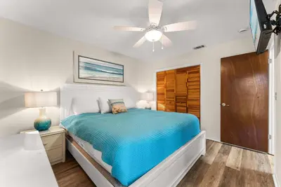 a bedroom with a bed and a ceiling fan at Charming Townhouse in Gulf Highland Beach Resort! Amenities Galore in Panama City Beach