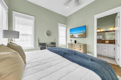 a large white bedroom with a large bed and windows at Gathering Thyme in Santa Rosa Beach