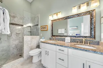 a bathroom with a toilet and a sink and a shower at Gathering Thyme in Santa Rosa Beach