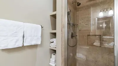 a bathroom with a shower with a glass door at Take It Eeaasy in Panama City Beach