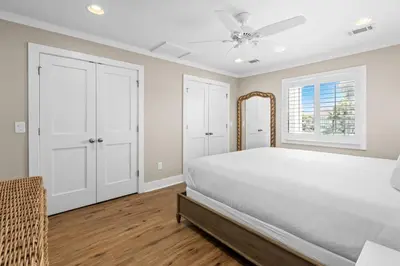 a white bedroom with a bed and a ceiling fan at Latitude 29 Unit 22 in Panama City Beach