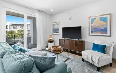 a living room with a couch and a tv at The Pointe 333 in Inlet Beach