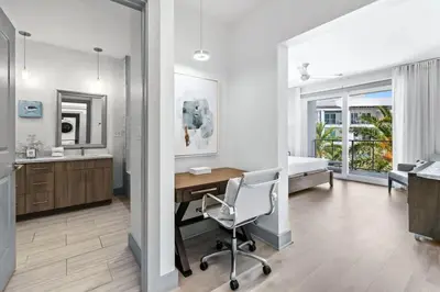 a bedroom with a desk and a bed and a chair at The Pointe 333 in Inlet Beach