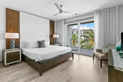 a bedroom with a large bed and a balcony at The Pointe 333 in Inlet Beach