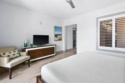 a bedroom with a bed and a tv and a couch at The Pointe 333 in Inlet Beach