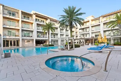 a swimming pool in front of a large building at The Pointe 333 in Inlet Beach