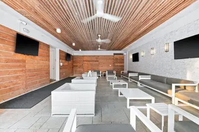 a waiting room with white benches and flat screens at The Pointe 333 in Inlet Beach
