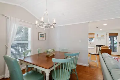 a dining room with a wooden table and chairs at Tutti Frutti in Santa Rosa Beach
