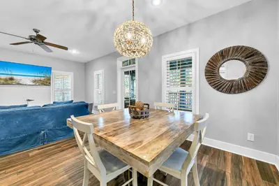 a dining room with a wooden table and chairs at The Grey Gull in Inlet Beach