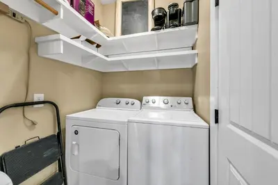 a small laundry room with a washer and dryer at The Grey Gull in Inlet Beach