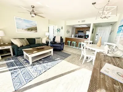 a living room with a couch and a table at Mermaid's Delight - PCB, FL in Panama City Beach