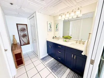 a bathroom with a sink and a mirror at Mermaid's Delight - PCB, FL in Panama City Beach