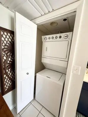 a kitchen with a stove and a washer and dryer at Mermaid's Delight - PCB, FL in Panama City Beach