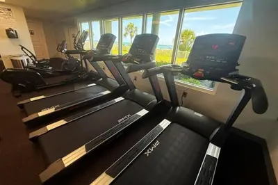 a row of exercise bikes in a gym with a window at Mermaid's Delight - PCB, FL in Panama City Beach