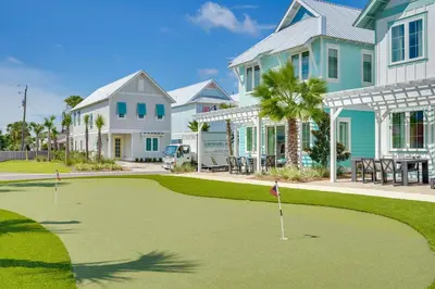 a golf course in front of a house at Margaritas and Parrots in PCB Beachy Bungalow! in Panama City Beach