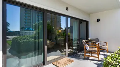 a balcony with sliding glass doors with a chair on it at Emerald Hill 35 in Santa Rosa Beach