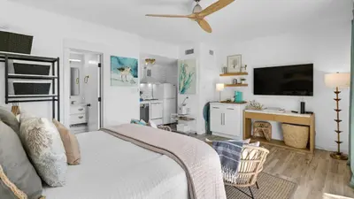 a bedroom with a bed and a desk and a tv at Emerald Hill 35 in Santa Rosa Beach
