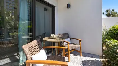 a patio with two chairs and a table at Emerald Hill 35 in Santa Rosa Beach