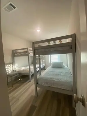 a bedroom with two bunk beds in a room at PCB Townhome in Panama City Beach