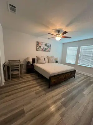 a bedroom with a bed and a ceiling fan at PCB Townhome in Panama City Beach