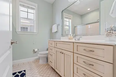 a bathroom with a sink and a toilet and a mirror at Seeking Sunsets 30A in Rosemary Beach