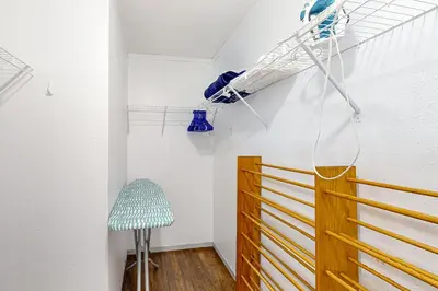 a room with a wooden door and a chair at Boat Dock! Canal-Front Family Retreat in PCB in Panama City Beach