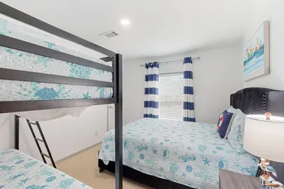 a bedroom with two bunk beds and a window at Boat Dock! Canal-Front Family Retreat in PCB in Panama City Beach