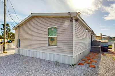 a small house with a window on the side of it at Boat Dock! Canal-Front Family Retreat in PCB in Panama City Beach