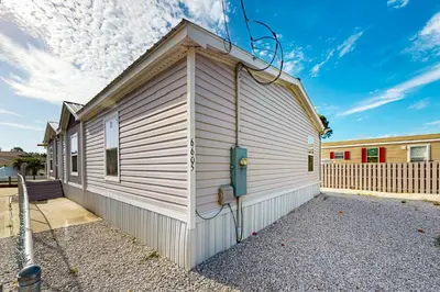 a small white building with a roof at Boat Dock! Canal-Front Family Retreat in PCB in Panama City Beach