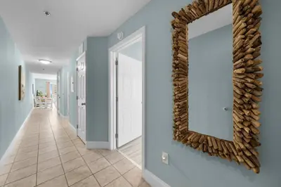 a large mirror on a wall in a hallway at Oceanview Family Friendly Resort Low Floor Condo! Steps 2 Beach! by Dolce Vita Getaways PCB in Panama City Beach