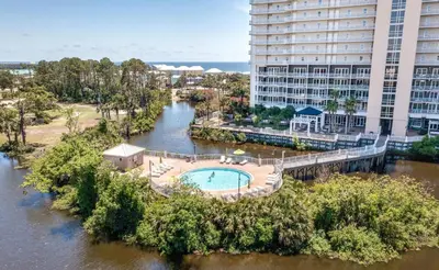 an aerial view of a river with a pool at Oceanview Family Friendly Resort Low Floor Condo! Steps 2 Beach! by Dolce Vita Getaways PCB in Panama City Beach