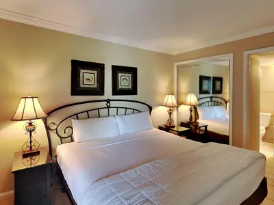 a bedroom with a large white bed with two lamps at Edgewater Tower III #708 in Panama City Beach