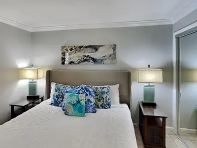 a bedroom with a large bed with two lamps at Edgewater Tower III #708 in Panama City Beach