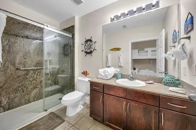 a bathroom with a shower and a toilet and a sink at Laketown Wharf 2135 in Panama City Beach