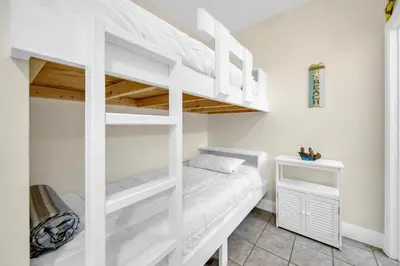 a white bunk bed in a white room with a bunk beduteneway at Laketown Wharf 2135 in Panama City Beach