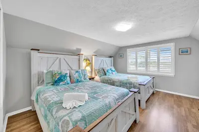 a bedroom with two beds and a window at Coastal Bliss in Panama City Beach