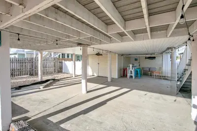 an empty porch of a house with a roof at Coastal Bliss in Panama City Beach