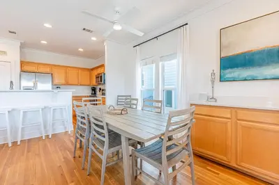 a kitchen and dining room with a wooden table and chairs at 30A Lemon Shello in Seacrest