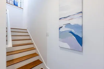 a staircase in a house with a painting on the wall at 30A Lemon Shello in Seacrest
