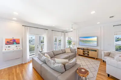 a living room with a couch and a tv at 30A Lemon Shello in Seacrest